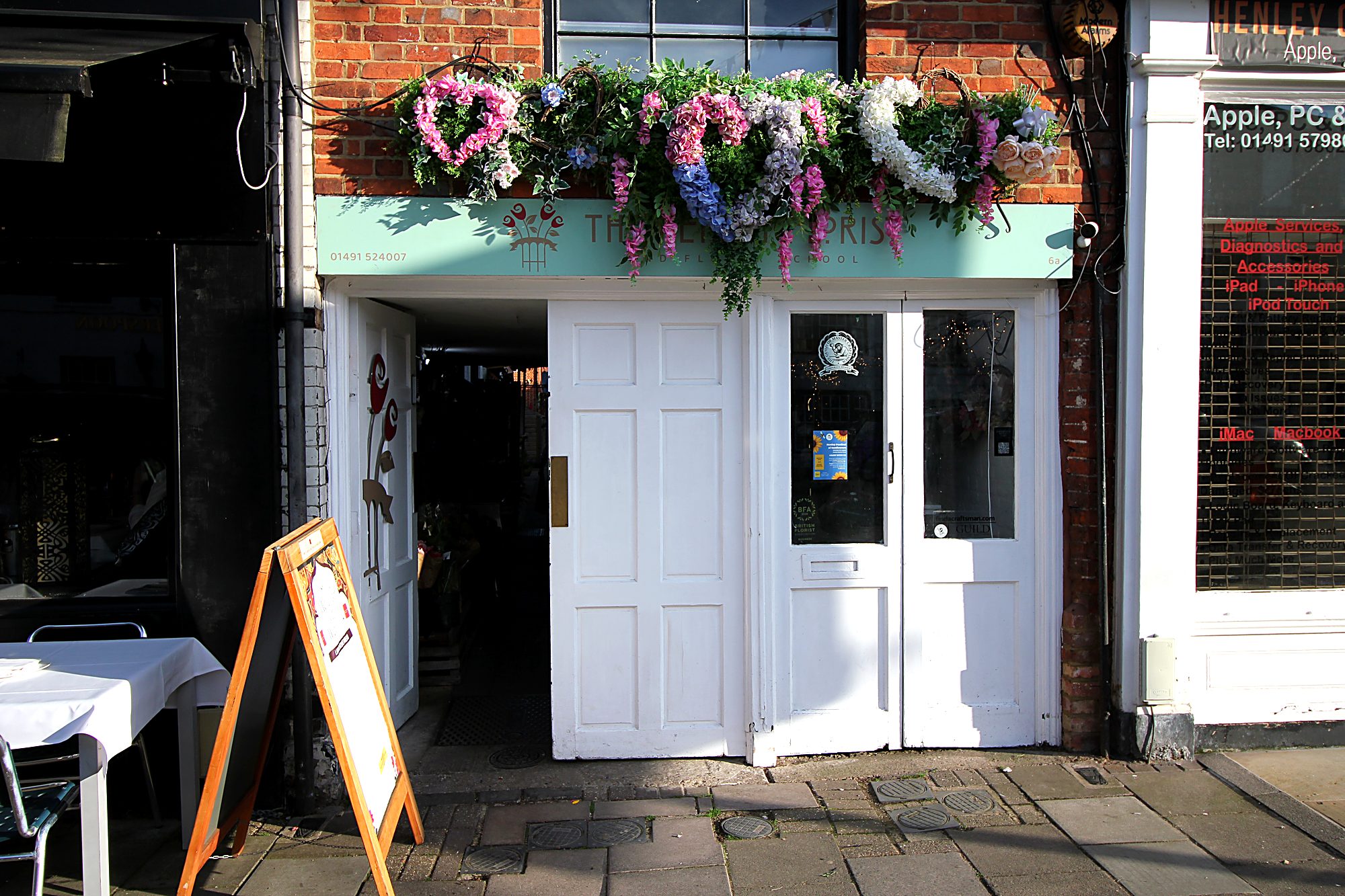 The front door off the high street, by the florist
