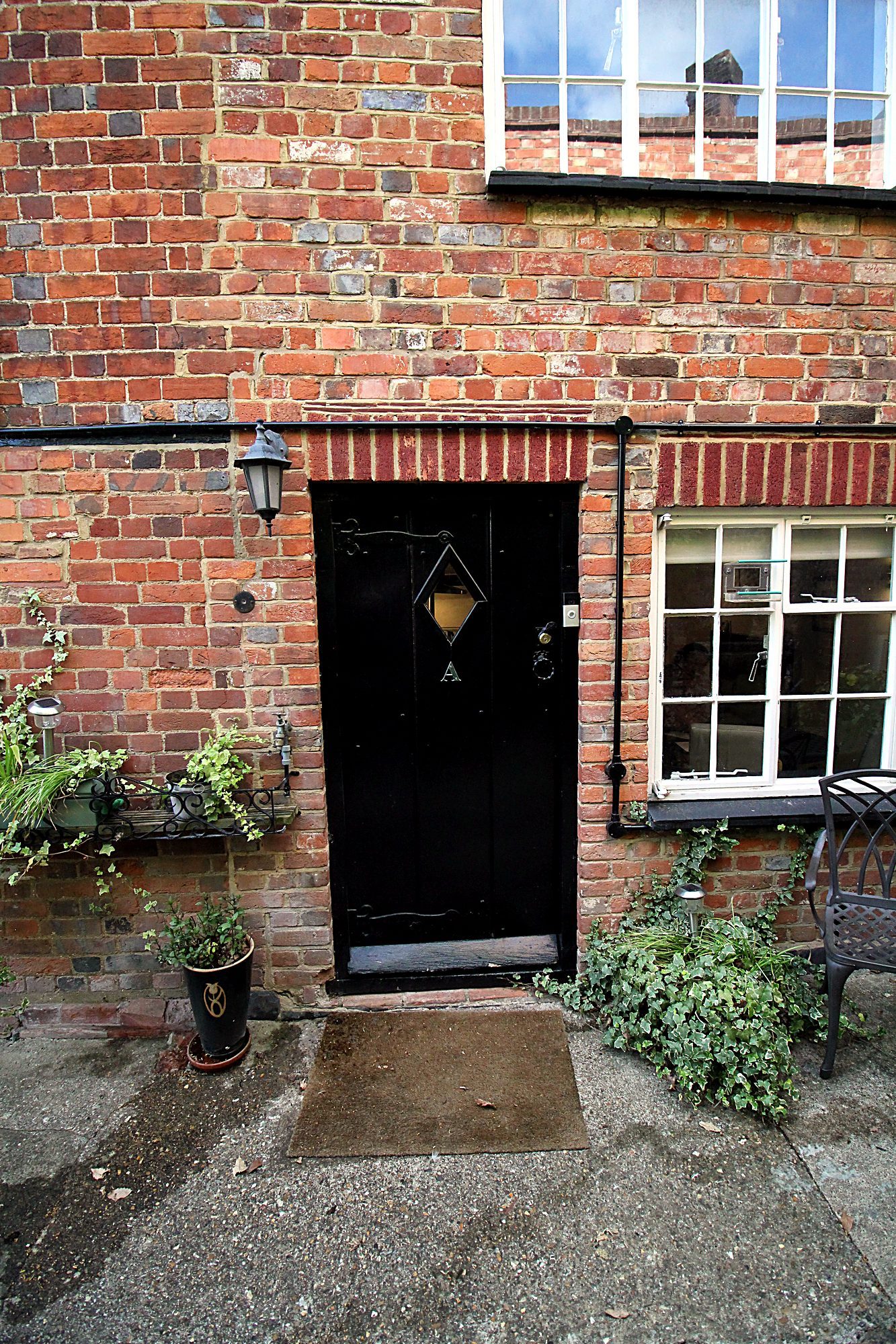 The cottage's front door off the historic alleyway