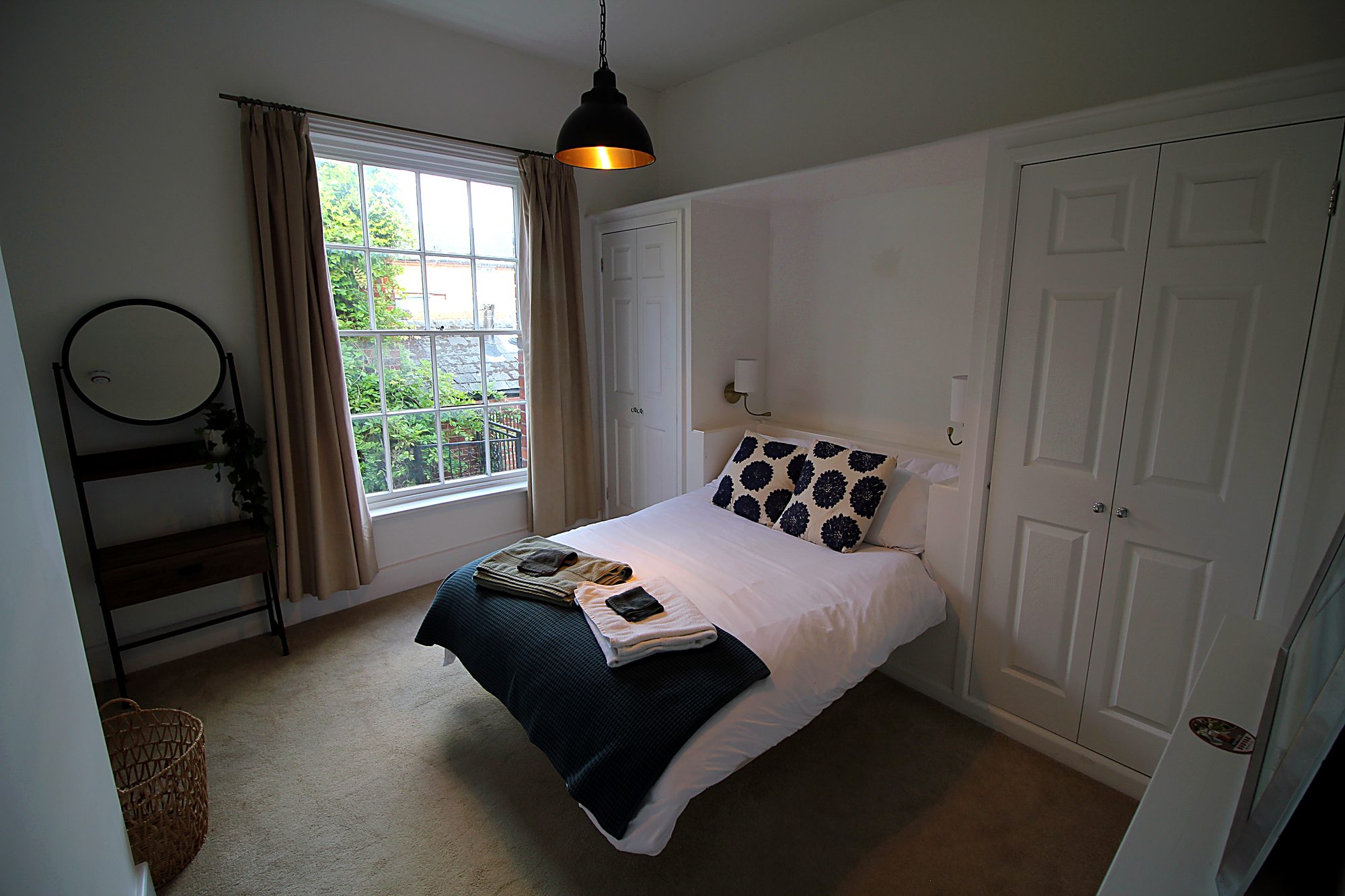 Second bedroom with window and wardrobe
